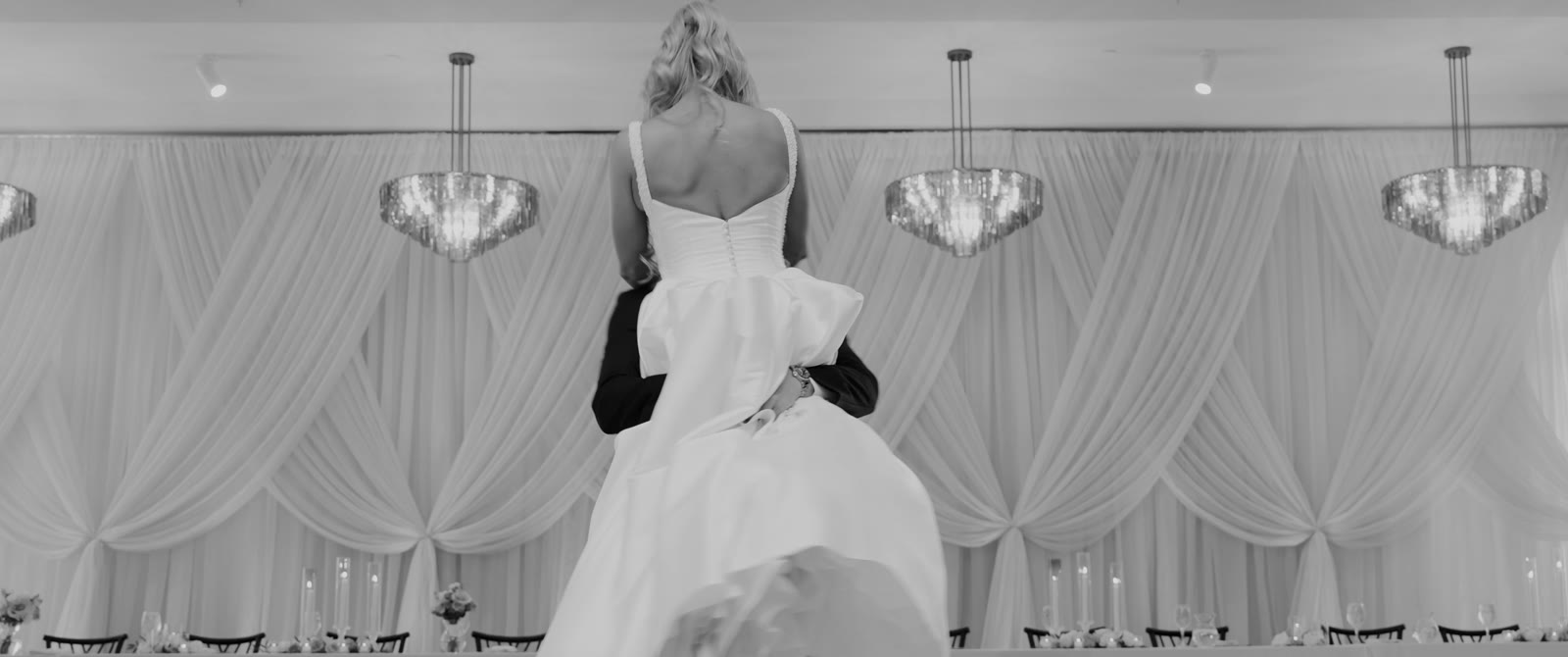 Black and white of Olivia and Alex dancing under chandeliers at Westwood Vowery & Estate.