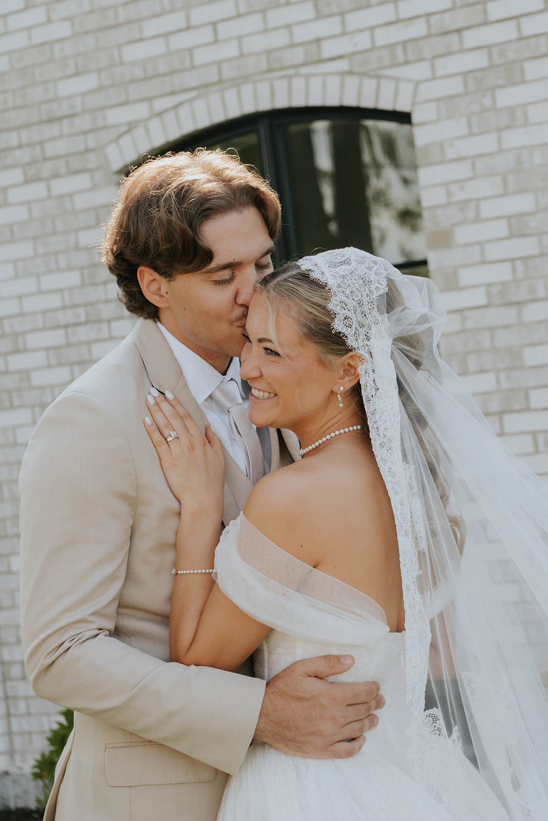Cami and Trey, portrait on the brick wall