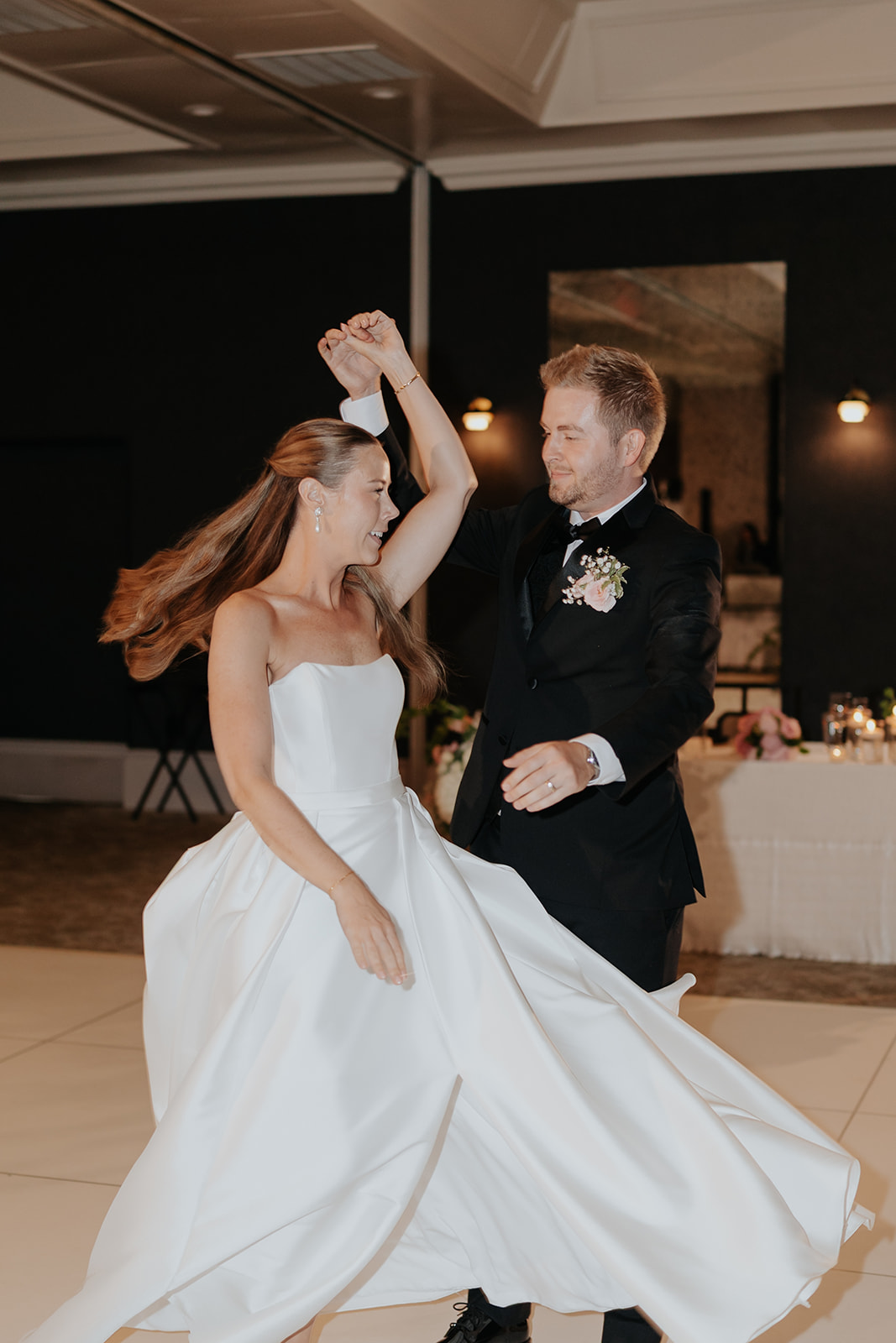 Jared spins Brooklyn across the dance floor, her gown and hair flying during their first dance