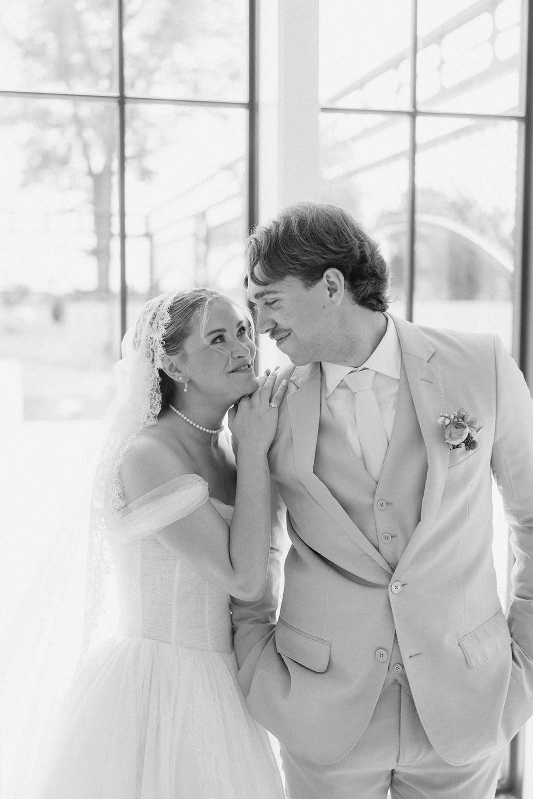 Black and white photo of Cami and Trey smiling close together, her hand resting on his shoulder.