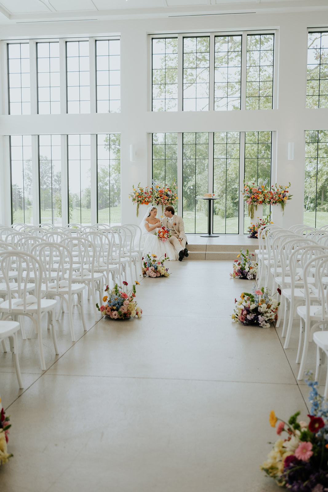 Cami and Trey sit together at the front of the empty chapel at Westwood Vowery & Estate before the ceremony.