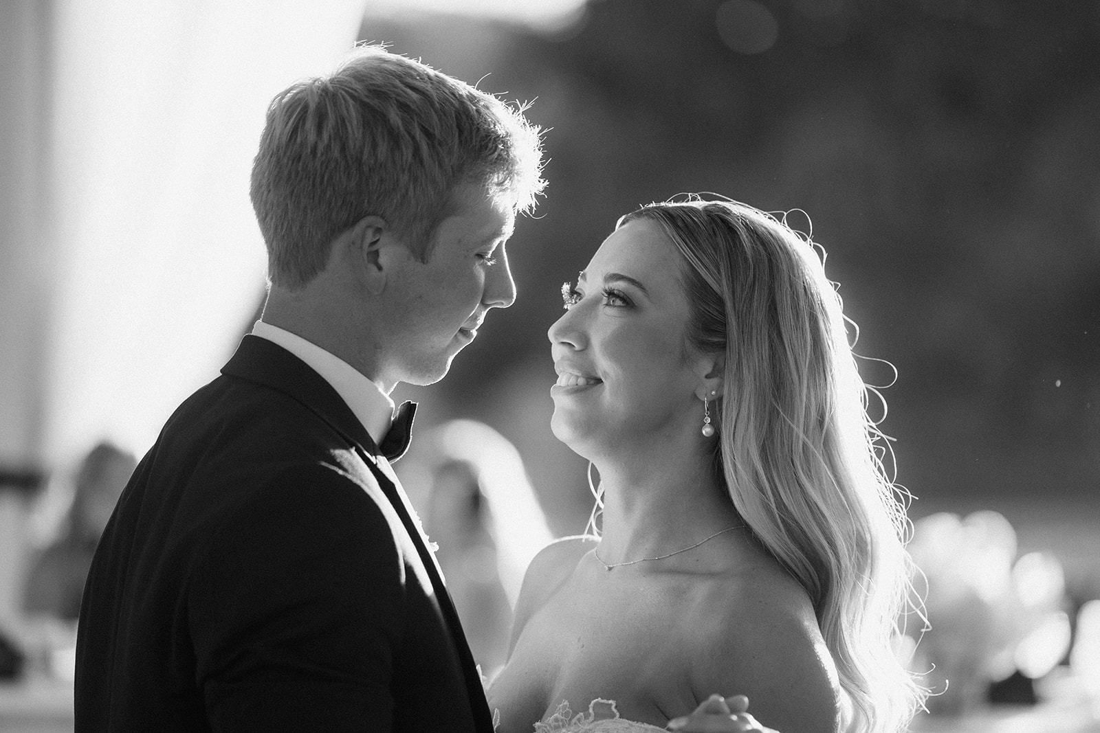 Black and white photo of Lauren smiling up at Grant during their first dance