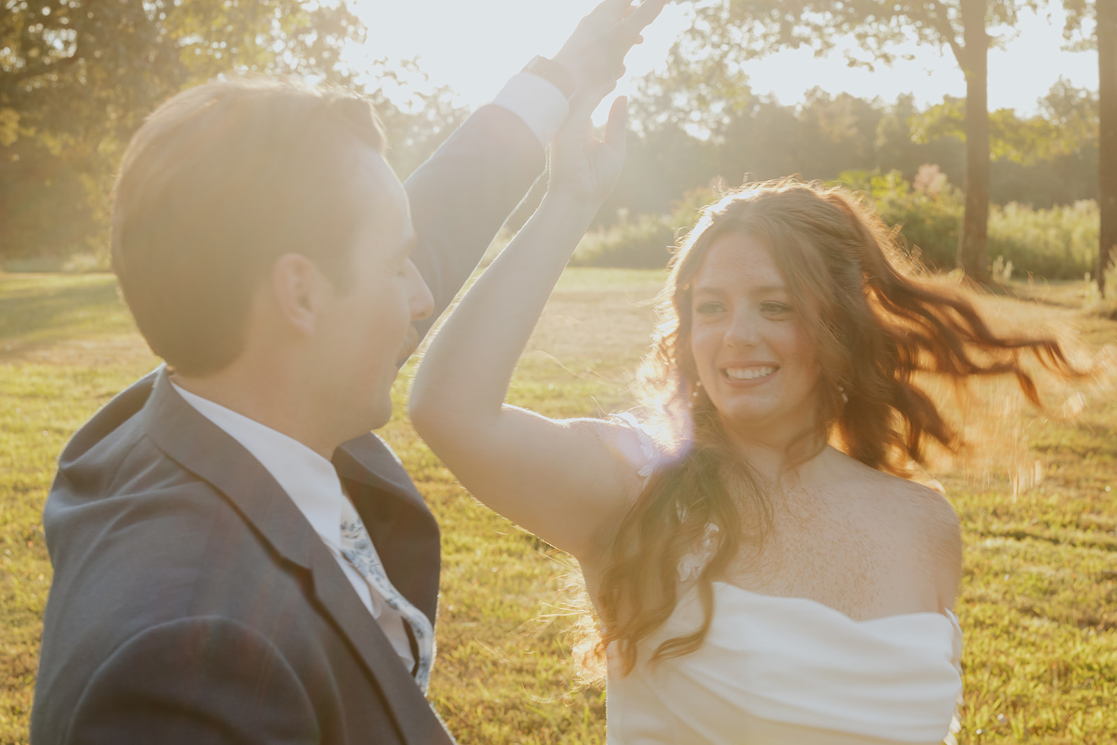 Matt spins Maci in golden hour light on the lawn at Burdoc Farms