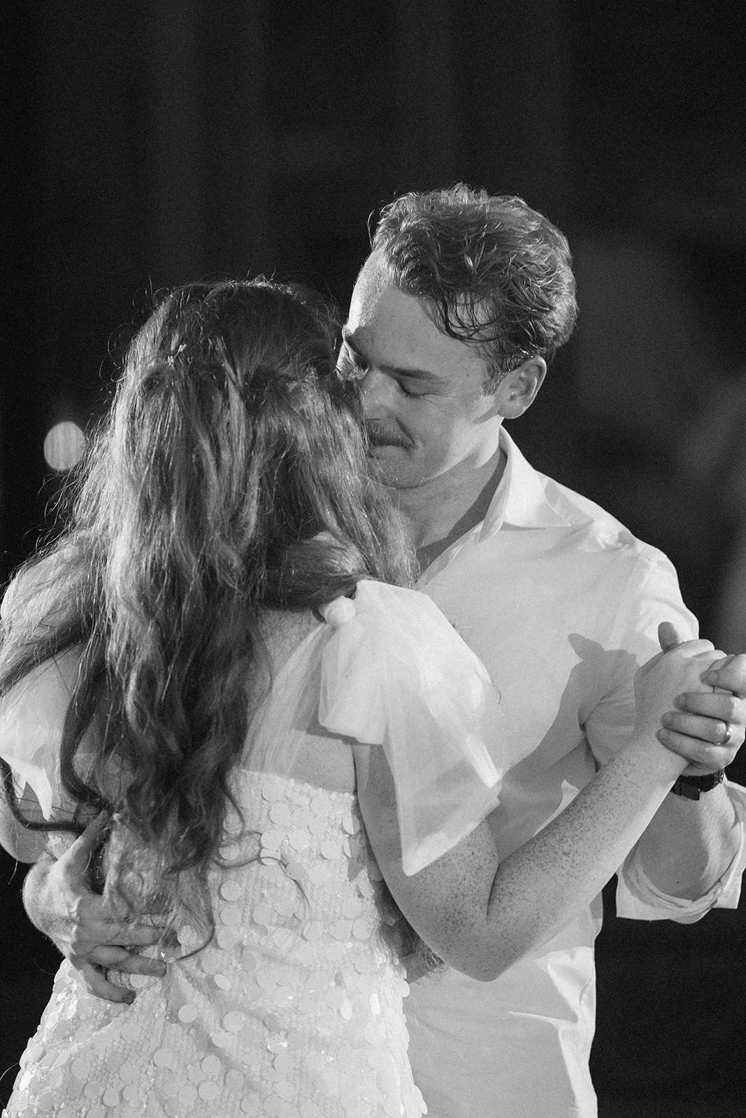 Black and white of Maci and Matt dancing close during the reception
