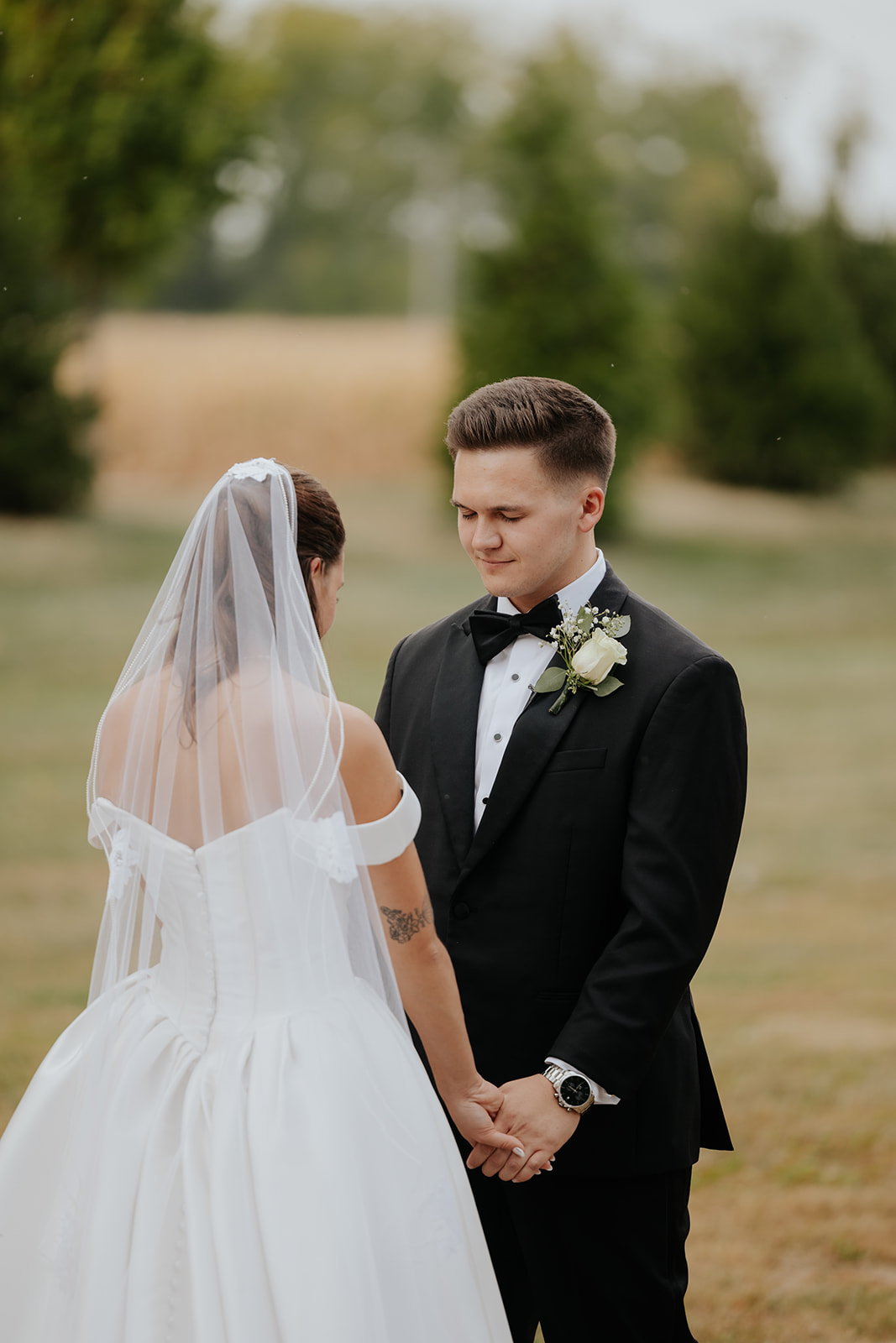 The bride and groom hold hands and gaze at each other during the ceremony