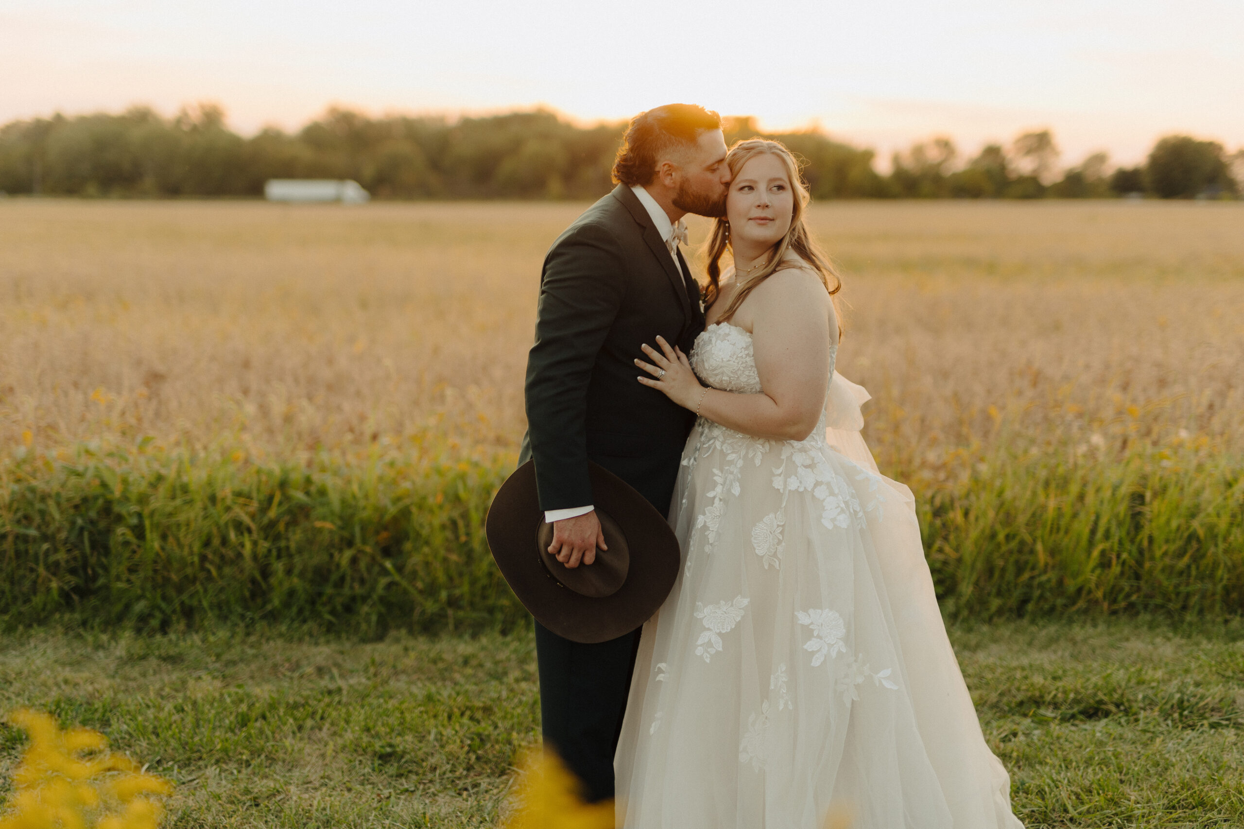 bride and groom getting photos at sunset